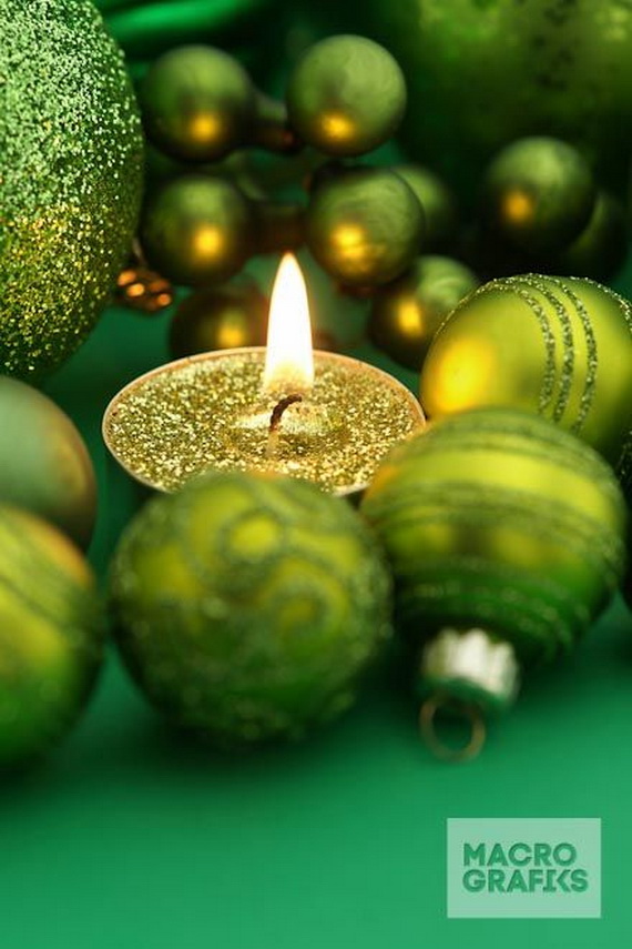 Green Holiday Candle with christmas decoration and copy space
