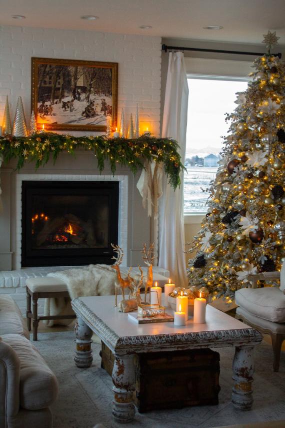 "Charming Rustic Living Room Christmas Decor with a roaring fireplace and illuminated holiday tree. A Warm Candlelit Table provides soft glow, contributing to a truly Comforting Festive Home Ambiance."