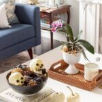 a-chic-Halloween-coffee-table-with-a-potted-bloom-a-bowl-with-spiders-skulls-and-pinecones-and-some-bones-in-a-shell (1)