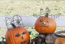 Create Unique Pumpkins using Junk for The Halloween Holiday Two orange pumpkins decorated as funny faces with industrial junk, one featuring a wire basket crown and the other displaying coiled mattress springs as hair.