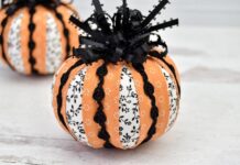 30 Creative Ways to Decorate a Pumpkin with Ribbon Fabric pumpkins adorned with striped orange and floral white ribbons, accented by black lace. They convey a festive and decorative autumn vibe.