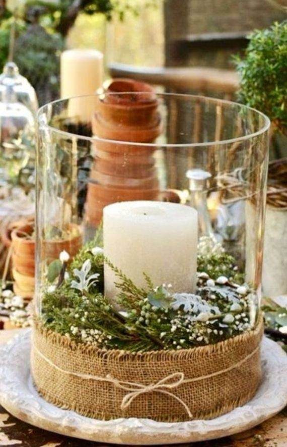 a-large-glass-lantern-with-evergreens-and-a-candle-wrapped-with-burlap