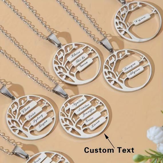 Silver tree-themed necklaces with customizable nameplates displayed on a beige background, conveying elegance and personalization options.