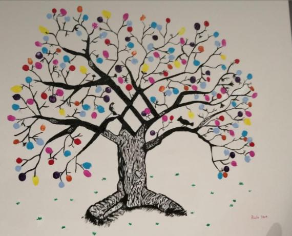 A vibrant tree with a textured black trunk and branches, adorned with multicolored circular leaves. The scene is playful and whimsical.