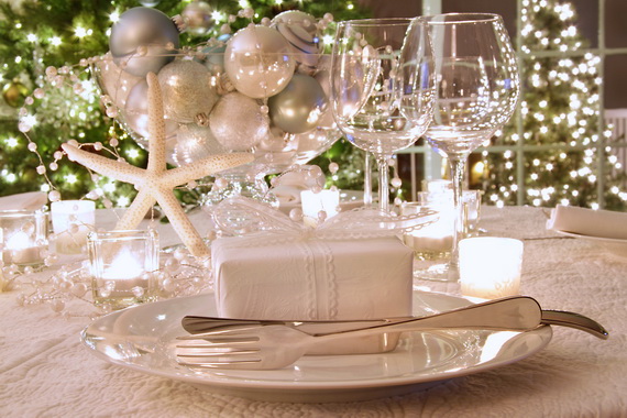 Elegantly lit  holiday dinner table with white ribboned gift