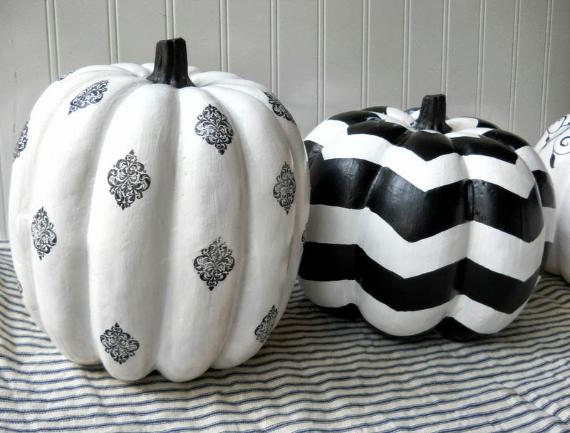 Two decorative pumpkins: one with black damask patterns on white, the other with black and white zigzag stripes.