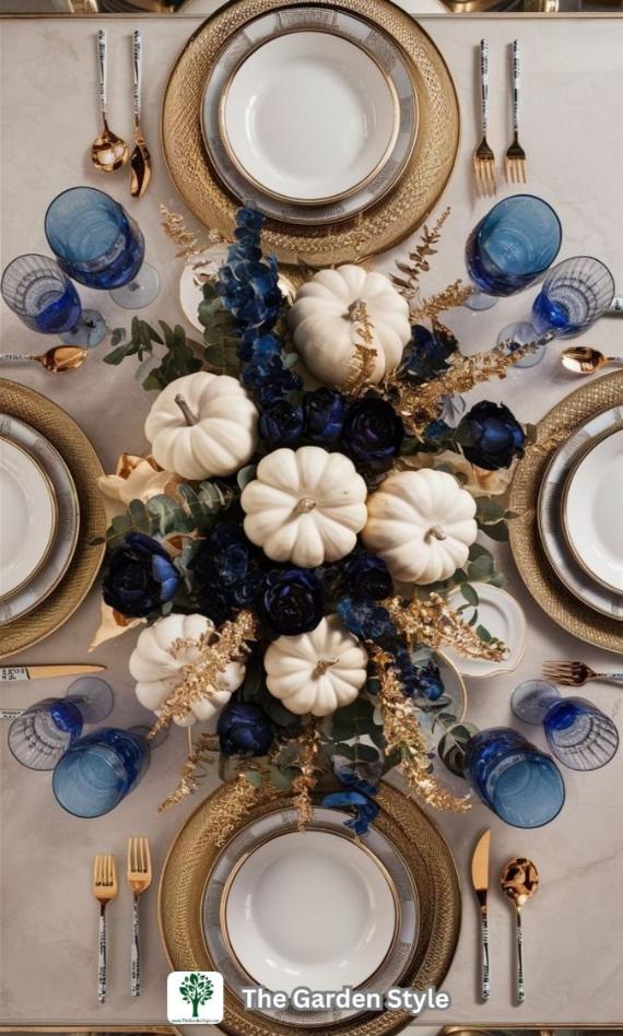 Royal Blue Fall Decorations with Gold Chargers feathering white pumpkins, dark blue roses, and golden leaves centerpiece. Blue glasses, gold cutlery, and layered plates. Luxurious and festive atmosphere.
