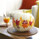 a-cool-pumpkin-centerpiece-with-bright-fall-leaves-attached-is-an-amazing-fall-decoration
