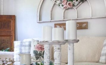 Simple but Spectacular 2013 Christmas Décor Ideas Cozy living room with distressed white candle holders on a glass table. Beige sofa with floral pillows, and a vintage arch decor with roses above.