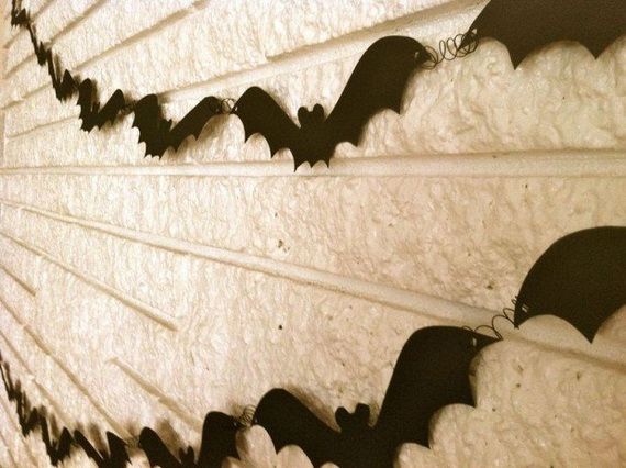 A wall adorned with various bats hanging from it, creating a spooky atmosphere.