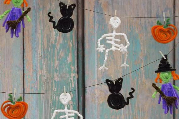 A Halloween decoration crafted from colorful paper Pipe Cleaner and yarn, featuring spooky designs and festive elements.