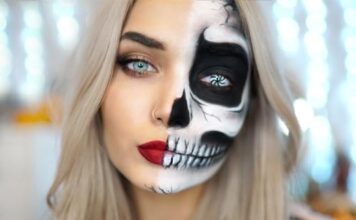 30 Best Scary Halloween Makeup Ideas–Creepy, Spooky and Horrifying Face Off Ideas Woman with long blonde hair wears Skeletal Half-Face paint, dramatic makeup, red lips, and intense eyes, creating a striking, mysterious contrast.