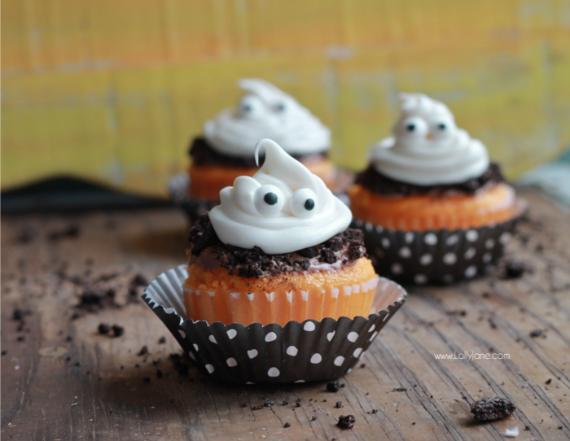 Halloween-themed cupcakes decorated with colorful frosting and playful googly eyes.