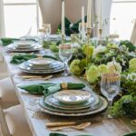 a-beautiful-green-Thanksgiving-tablescape-with-green-plates-napkins-flowers-and-greenery-and-some-gold-touches
