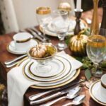a-refined-Thanksgiving-tablescape-with-gold-rimmer-plates-and-glasses-plus-gilded-pumpkins-is-cool