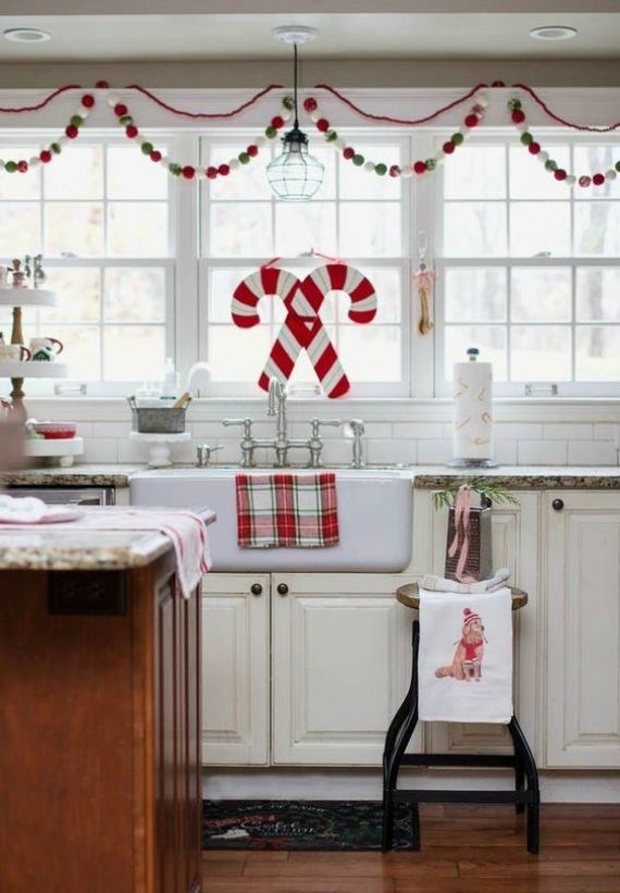 a-red-white-and-green-pompom-garland-candy-cane-decor-and-plaid-textiles-for-Christmas