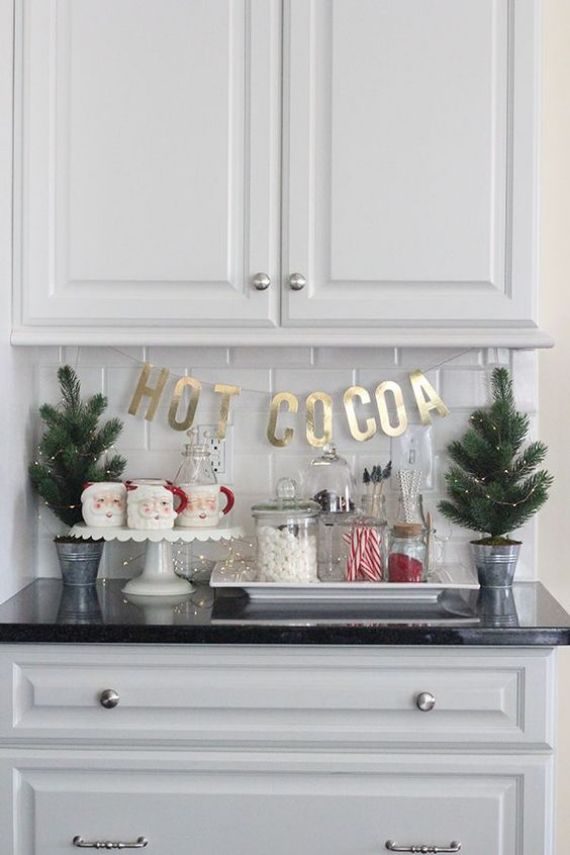 mini-Christmas-trees-with-lights-Santa-mugs-sweets-and-gold-letters-for-a-cool-and-cute-Christmas-nook