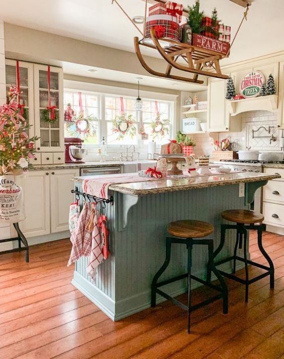 red-grey-and-white-Christmas-kitchen-decor-a-sleigh-over-the-kitchen-island-printed-linens-and-a-mini-Christmas-tree