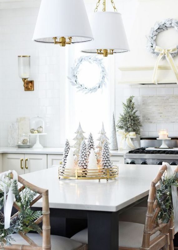 whitewashed-evergreen-wreaths-a-mini-Christmas-tree-candles-ornaments-and-a-white-Christmas-tree-centerpiece
