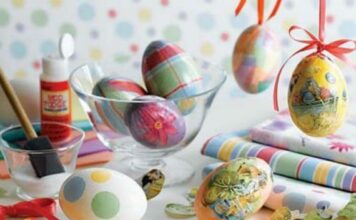 11 Easy Easter Craft Ideas for All Ages Colorful Decoupage Easter Eggs in a glass bowl with vibrant patterns on a colorful table, surrounded by crafting supplies, conveying a festive spring theme.