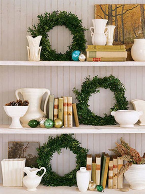 Winter-decorative-wreath-on-kitchen-shelf-including-gingerbread-house-and-pastries