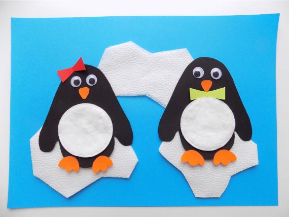 Two cartoon Cotton Pads Penguin on white ice shapes; one wears a red bow and the other a green bowtie. The background is bright blue.