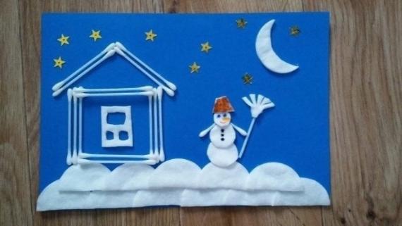 A Winter Wonderland made of cotton pad. A house and snowman on cotton clouds under a night sky with stars and a crescent moon. Playful and creative.