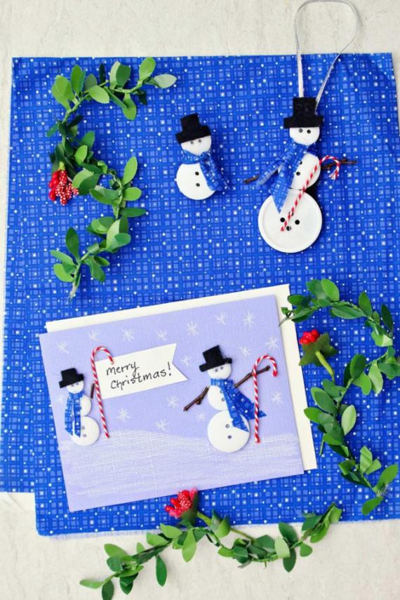Crafts for Christmas: A festive blue backdrop features snowman decorations and a card reading "Merry Christmas!" surrounded by greenery.