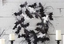 Affordable bat decorations for Halloween: DIY ideas and tips This cool black and white Halloween wreath is made of black felt bats and white ghosts plus some black twigs.