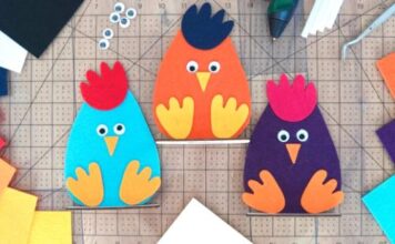 Adorable Easter Felt Craft Ideas for All Ages Three colorful felt chicken crafts—blue, orange, and purple—sit on a cutting mat with craft supplies around them, conveying a playful tone.